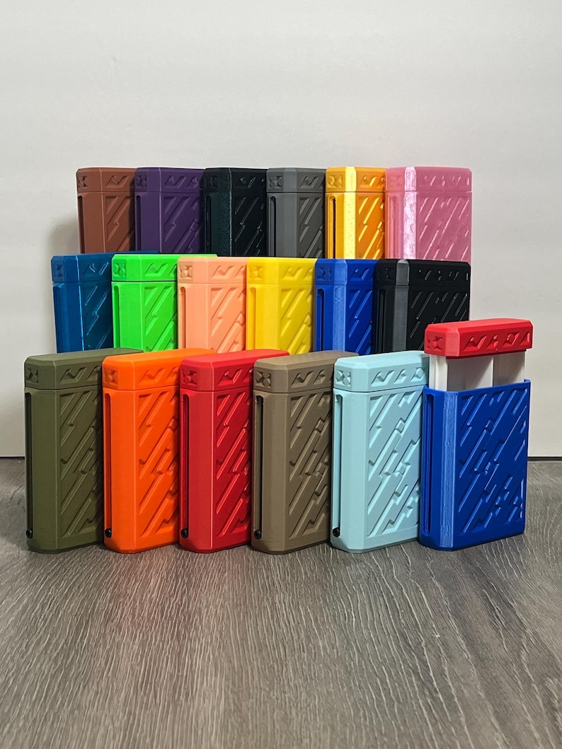 May include: A collection of colorful rectangular cases with textured diagonal line patterns. The cases are in various colors, including green, orange, red, brown, blue, and yellow. The cases are arranged on a wooden surface.