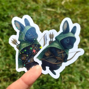 May include: A set of three ceramic mugs with a speckled, matte finish. Each mug features a different color: light blue, cream, and gray. The mugs have a simple, modern design and a comfortable handle.