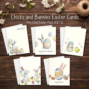 May include: A set of five Easter cards with envelopes, featuring watercolor illustrations of bunnies, chicks, and decorated eggs. The cards have the text "Happy Easter" and "Happy Easter, Little One!" on them. The cards are on a wooden surface.