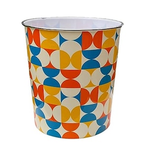May include: A white metal bin with a geometric pattern in shades of orange, yellow, and blue.