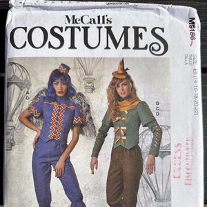 May include: A sewing pattern for two costumes. The pattern is for sizes 14-16-18-20-22. The costumes are a steampunk-inspired aviator and a woodland fairy. The pattern is from McCall's Costumes.