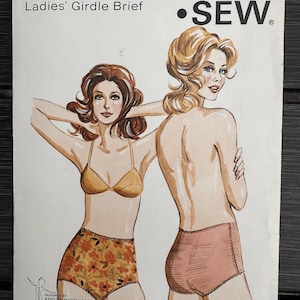 May include: A Kwik Sew pattern envelope for a girdle brief, pattern 240, featuring illustrations of two figures wearing briefs. One figure wears a floral print brief, the other a solid pink brief. Text includes Pattern 240, Sizes S-M-L-XL, and Ladies' Girdle Brief.