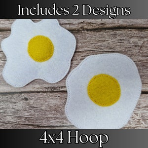May include: Two felt fried egg designs for embroidery. The eggs are white with yellow yolks and are stitched with a white thread. The text "Includes 2 Designs" and "4x4 Hoop" is also included in the image.