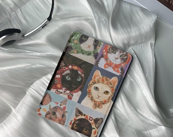 Pode incluir: Uma capa multicolorida para um leitor de e-books com uma colagem de gatos usando diferentes chapéus e lenços.