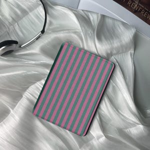 May include: A pink and green striped e-reader cover.