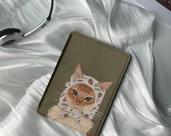May include: A green e-reader case with a cute illustration of a cat wearing a white and pink floral bonnet with strawberries. The cat has orange fur and green eyes.
