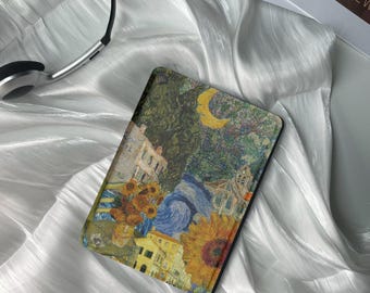 May include: A black e-reader case with a colorful collage design featuring sunflowers, a crescent moon, and a cityscape. The design is reminiscent of famous paintings by Vincent van Gogh.