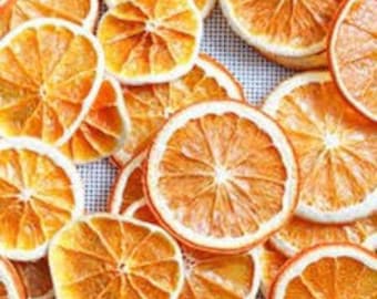 May include: Dried orange slices, a natural, rustic, and fragrant decoration for crafts, home decor, or baking. The slices are a vibrant orange color and have a slightly translucent appearance.