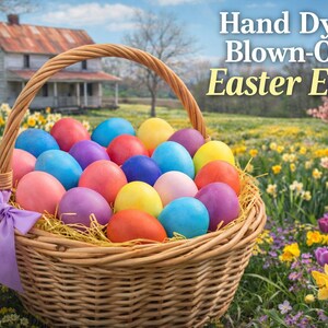May include: A wicker basket filled with colorful, hand-dyed blown-out Easter eggs. The eggs are in various colors, including pink, blue, yellow, and purple. The basket has a purple ribbon tied to the handle. The background features a field of flowers and a house.
