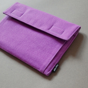 May include: A lilac fabric case with a flap closure. The case is rectangular with a textured surface. The flap features two stitched rectangular details. The brand name "JIJIU" is on a small black tag.