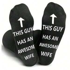 May include: Black socks with white text and an upward-pointing arrow. The text on the socks reads "THIS GUY HAS AN AWESOME WIFE."