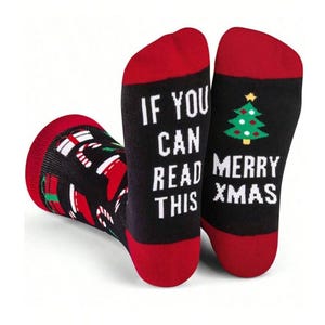 May include: Black Christmas socks with red toes and cuffs. One sock reads "If you can read this" in white text. The other sock reads "Merry Xmas" with a green Christmas tree graphic. The other sock has a pattern of Christmas gifts and candy canes.