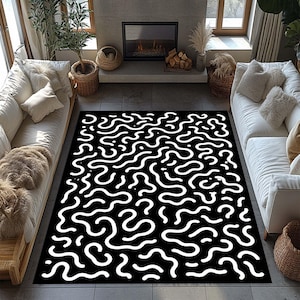 May include: A rectangular area rug featuring a high-contrast black background with a repeating pattern of white, fluid, organic, and squiggly lines that snake across the entire surface in a dense, interconnected, and abstract design.