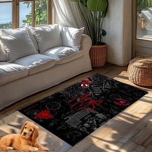 May include: Black rectangular area rug featuring a red Spider-Man design. The rug has a detailed pattern with Spider-Man's mask, web designs, and scientific diagrams. The rug is placed on a wooden floor.