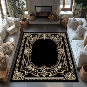 May include: A rectangular area rug featuring a solid black center framed by an ornate gold border. The design includes intricate scrollwork, symmetrical floral motifs, and geometric lines that create a decorative frame around the dark field.