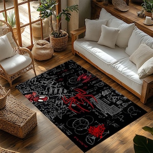 May include: Black rectangular area rug featuring a red spider and spider web design. The rug has a white mathematical formula pattern. The rug is placed on a wooden floor in a living room setting.