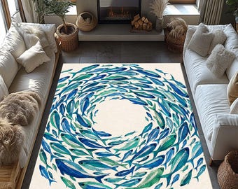 May include: A rectangular area rug featuring a circular pattern of watercolor-style fish in various shades of blue, teal, and green. The fish are arranged in a swirling school formation around a central cream-colored negative space.