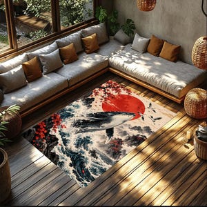 May include: A rectangular area rug featuring a detailed illustration of a whale breaching from dark blue ocean waves. The design includes a large red sun, flying cranes, and red maple leaves against a light background, creating a scene.