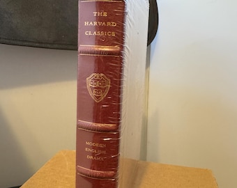 May include: A burgundy leather-bound book with gold lettering. The title is "The Harvard Classics" and the subtitle is "Modern English Drama". The book is wrapped in plastic.