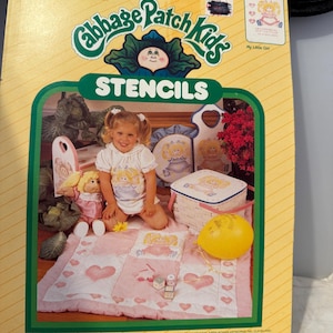 May include: Package of Cabbage Patch Kids stencils for home and fashion decor. The package features a young girl holding a Cabbage Patch Kid doll. The stencils are made of Mylar and are pre-cut. The package includes instructions.