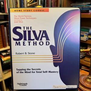 May include: A boxed set titled "The Silva Method" with a navy blue and white design. The cover features the title in large, bold letters and a silhouette of a person's head with lines. The box is a home study course by Robert B. Stone.