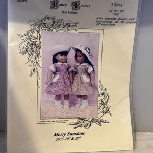 May include: A doll dress pattern for 18-inch and 20-inch dolls. The pattern is called "Merry Sunshine" and is for a dress with a floral print. The pattern includes instructions for making the dress and a hat.
