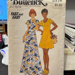 May include: Vintage Butterick sewing pattern envelope. The cover shows illustrations of two women in dresses. One dress is a long, flowing design with a blue and yellow floral pattern. The other is a short, yellow dress. The text "FAST and EASY" is visible.