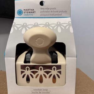 May include: A Martha Stewart Crafts deep edge punch in a box. The punch is off-white with a decorative crochet loop design. The box has text in English, Spanish, and French.