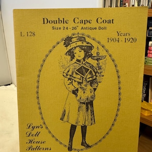 May include: A vintage pattern for a Double Cape Coat for an antique doll, size 24-26 inches. The cover is mustard yellow with an illustration of a doll wearing the coat. Text includes "Years 1904-1920" and "Lyn's Doll House Patterns."