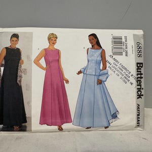 May include: A Butterick sewing pattern showing illustrations of three formal dresses. The pattern includes sizes 22W, 24W, and 26W. The Jo-Ann Fabrics pattern is labeled "Fast & Easy".