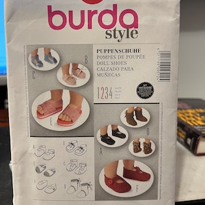May include: A Burda Style sewing pattern for doll shoes. The pattern includes instructions for making six different styles of shoes, including sandals, boots, and flats. The pattern is labelled with the number 9512 and includes seam and hem allowances.