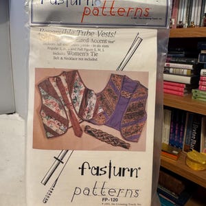 May include: A sewing pattern package for reversible tube vests. The package features illustrations of vests and a tie, with the text "fasturn patterns" and "Reversible Tube Vests!" printed on the front. Includes full size pattern pieces in six sizes.