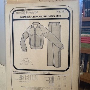 May include: A vintage sewing pattern for a Women's Chinook running suit, No. 131, by The Green Pepper Inc. The pattern includes illustrations of a jacket and pants, along with body measurements and fabric requirements. The pattern is sealed in a clear plastic bag.
