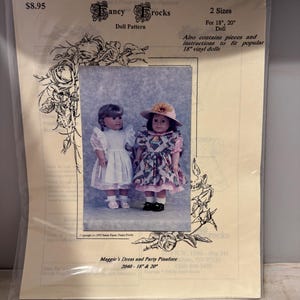 May include: A doll dress pattern for 18-inch and 20-inch dolls. The pattern is called "Maggie's Dress and Party Pinafore" and the pattern number is 2040. The pattern includes instructions to fit popular 18-inch vinyl dolls.