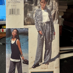 May include: A sewing pattern for a pair of pants and a jacket. The pattern is for sizes 18-20-22. The pattern number is 8951. The pattern is called "Vogue Sport" and is labeled "Very Easy".