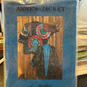 May include: A quilting pattern for a jacket called "Anne's Jacket" from "A Quilter's Wardrobe" with a pattern number of 8012. The pattern shows a blue and black jacket with a colourful patchwork design on the front.