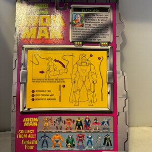 May include: A plastic action figure of Blacklash from the Marvel Comics universe. The figure is posed with a whip in his right hand and a cape flowing behind him. The figure is part of the Iron Man toy line. The back of the packaging features a description of the character and a list of other figures in the line.