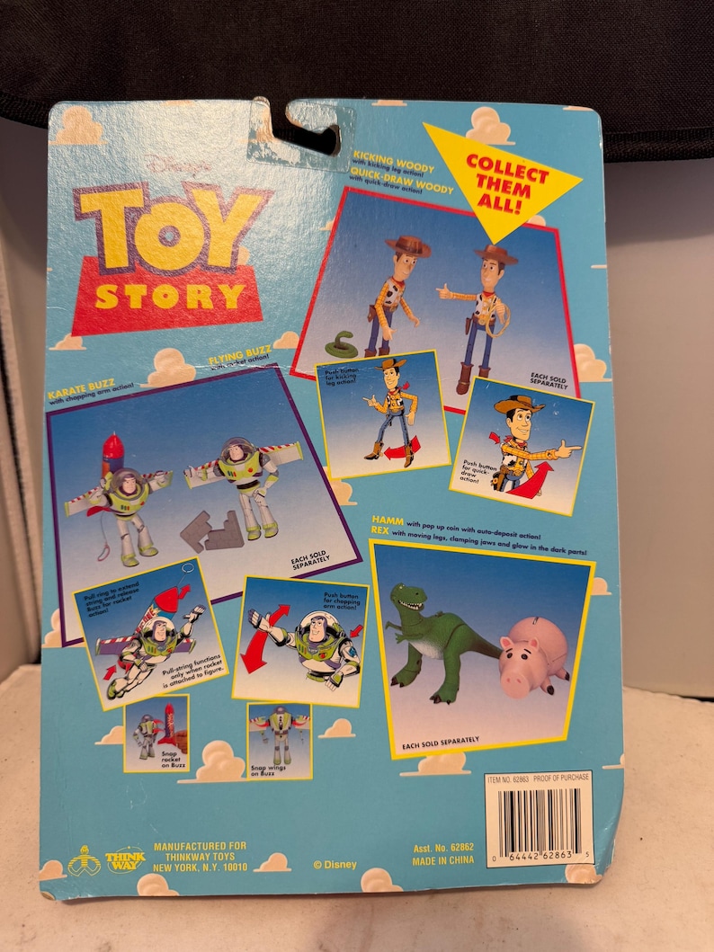 May include: A blue Toy Story action figure package featuring Woody, Buzz Lightyear, Hamm, and Rex. The package includes illustrations of the characters and the text "COLLECT THEM ALL!"