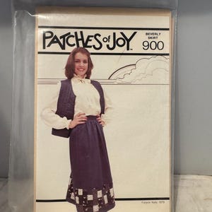 May include: A vintage sewing pattern for a Beverly skirt, called "Patches of Joy" with a model wearing the skirt and a vest. The pattern number is 900. The pattern is from Joyce Kelly, 1979.