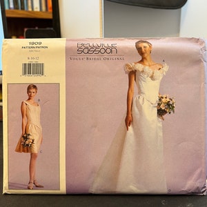 May include: A sewing pattern for a wedding dress, featuring a white dress with a lace bodice and a flowing skirt. The pattern is for sizes 8-10-12 and is a Vogue Bridal Original by Bellville Sassoon.