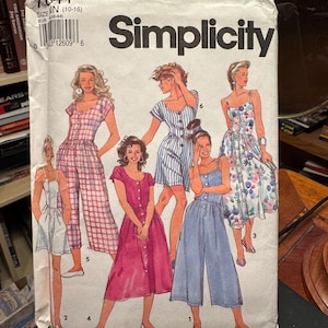 May include: A Simplicity sewing pattern envelope, number 7841, size N (10-16). The front features illustrations of six different garment styles, including dresses and jumpsuits with button-front closures, varying sleeve lengths, and patterns.