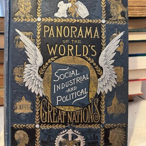May include: Antique book titled "Panorama of the World's Great Nations" with gold lettering and illustrations on a dark blue cover. The cover features images of people, buildings, and wings. The book's title is prominently displayed.