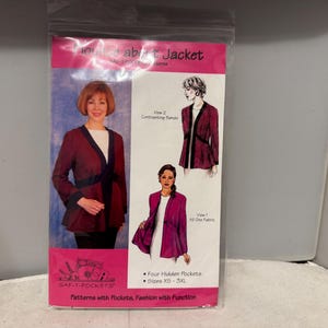 May include: A sewing pattern package for a jacket. The package features a woman wearing a burgundy jacket with black trim. The package also shows illustrations of the jacket in different styles. The text on the package reads "Voice about Jacket" and "SAF-T-POCKETS".