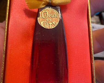 May include: A vintage Coty perfume bottle in a red box. The bottle is a deep red color with a black cap and a gold bow. The label reads "L'Origan de Coty New York". The box is lined with red satin.