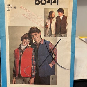 May include: Simplicity sewing pattern number 8644 for a vest. The pattern includes instructions for making two different styles of vests, one in red and one in blue. The pattern is for sizes 10-12.