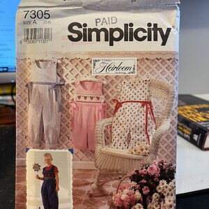May include: Simplicity sewing pattern number 7305 for a child's overalls. The pattern includes three different styles of overalls, with a floral print, a striped print, and a solid color. The pattern is labeled "Classic Heirloom Sewing".