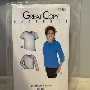 May include: A sewing pattern for a blouse called the Brighton Blouse. The pattern is from Great Copy Patterns and is number #2480. The pattern includes three different views of the blouse, one with short sleeves, one with long sleeves, and one with a collar.