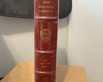 May include: A burgundy leather-bound book with gold lettering. The title is "The Harvard Classics" and the book is titled "Don Quixote Part I" by Cervantes. The book is a collector's edition.