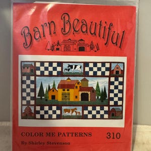 May include: Barn Beautiful quilt pattern with a red, white and blue checkered background. The pattern features a barn with a yellow roof, green trees and cows. The text "Color Me Patterns" and "By Shirley Stevenson" is printed below the pattern. The number "310" is printed in the top right corner.