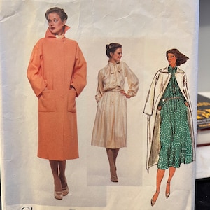 May include: A vintage Vogue Paris Original sewing pattern for a coat and dress by Christian Dior. The pattern number is 1837. The pattern features three models wearing the designs. The coat is a light pink color and the dress is a light beige color with a white trim. The second dress is a green and white polka dot print.
